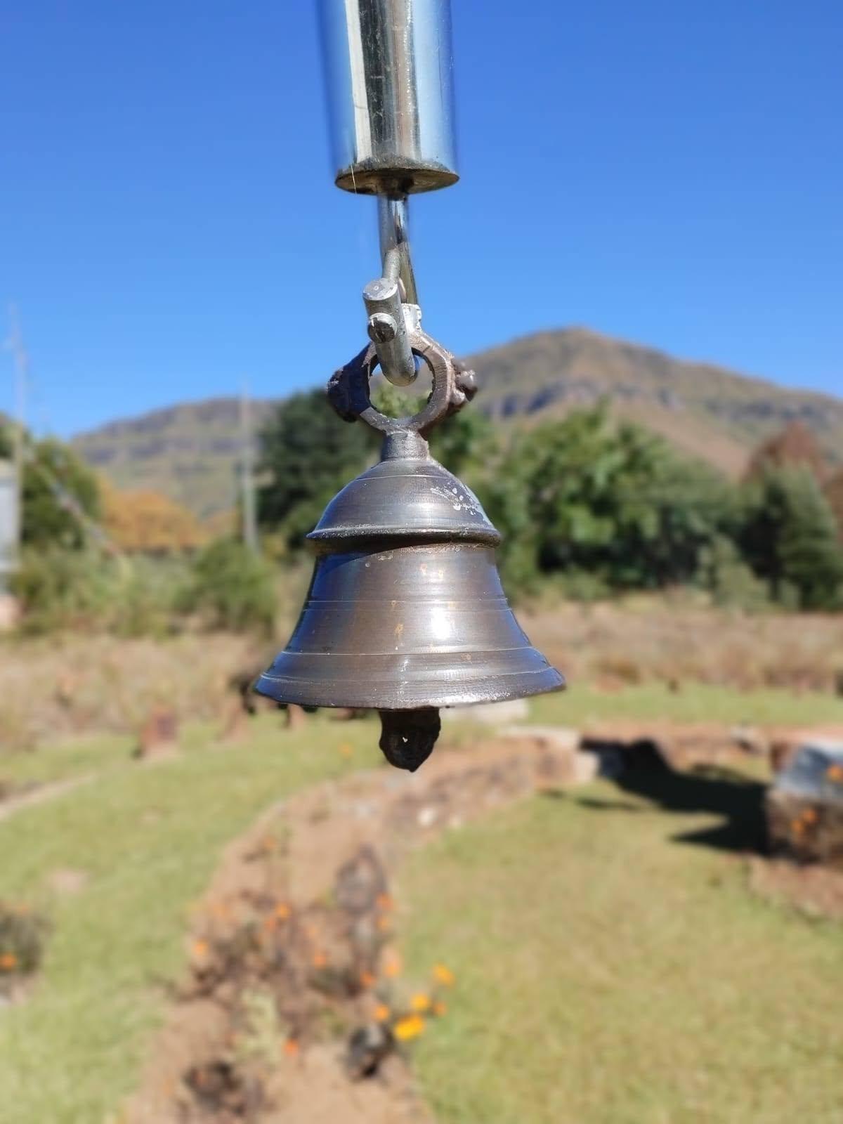Temple bell with mountain backdrop