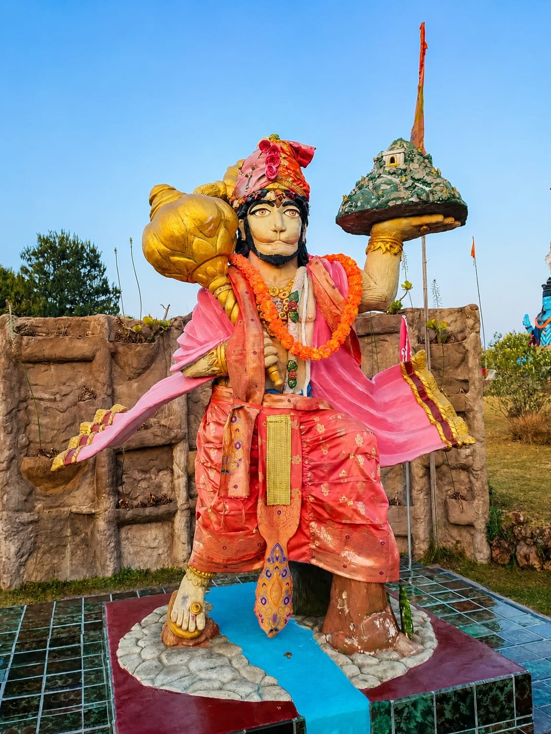 Lord Hanuman statue at Shiva Kshetra, carrying the mountain of healing herbs and his gada