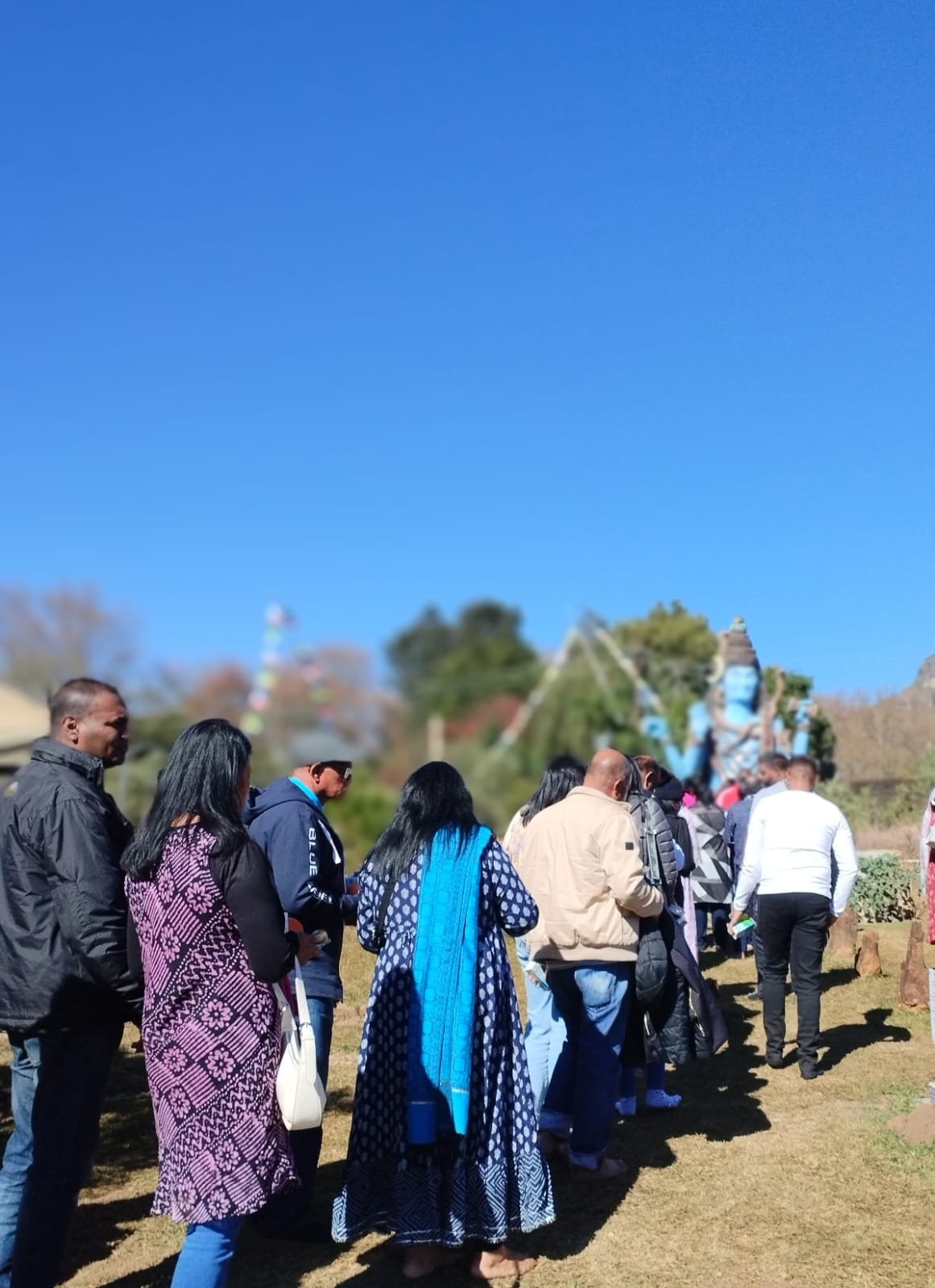 Pilgrims walking toward the Shiva murti